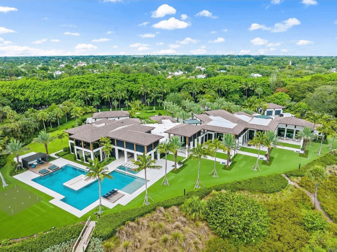 An aerial view of a sprawling luxury estate with a large pool